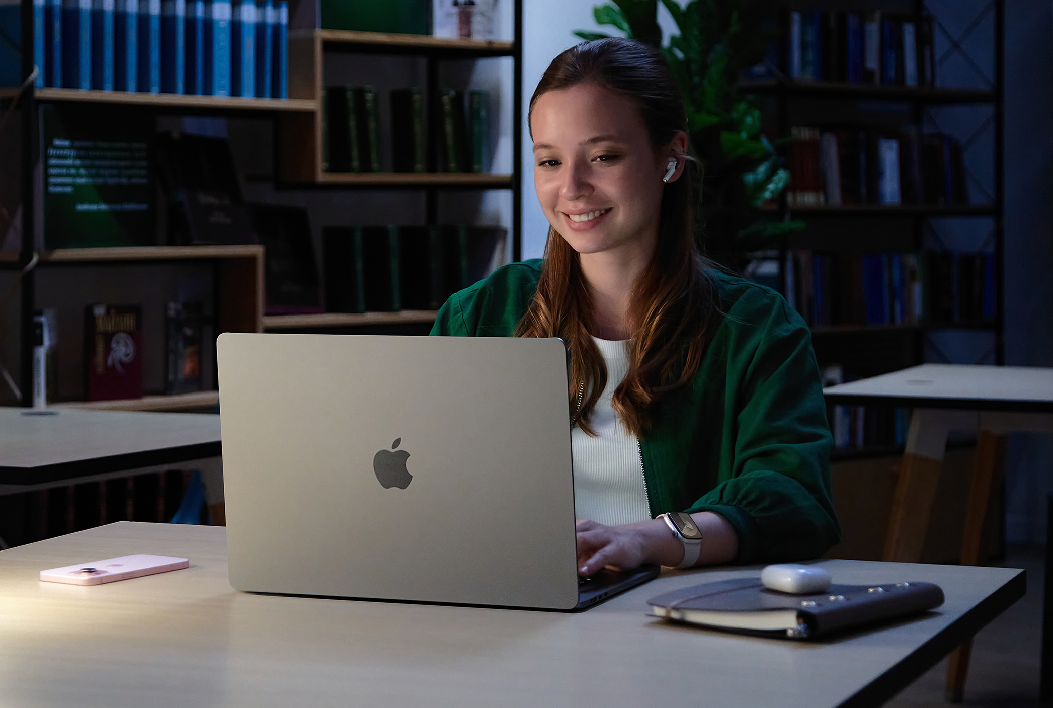 Girl working with MacBook in a library